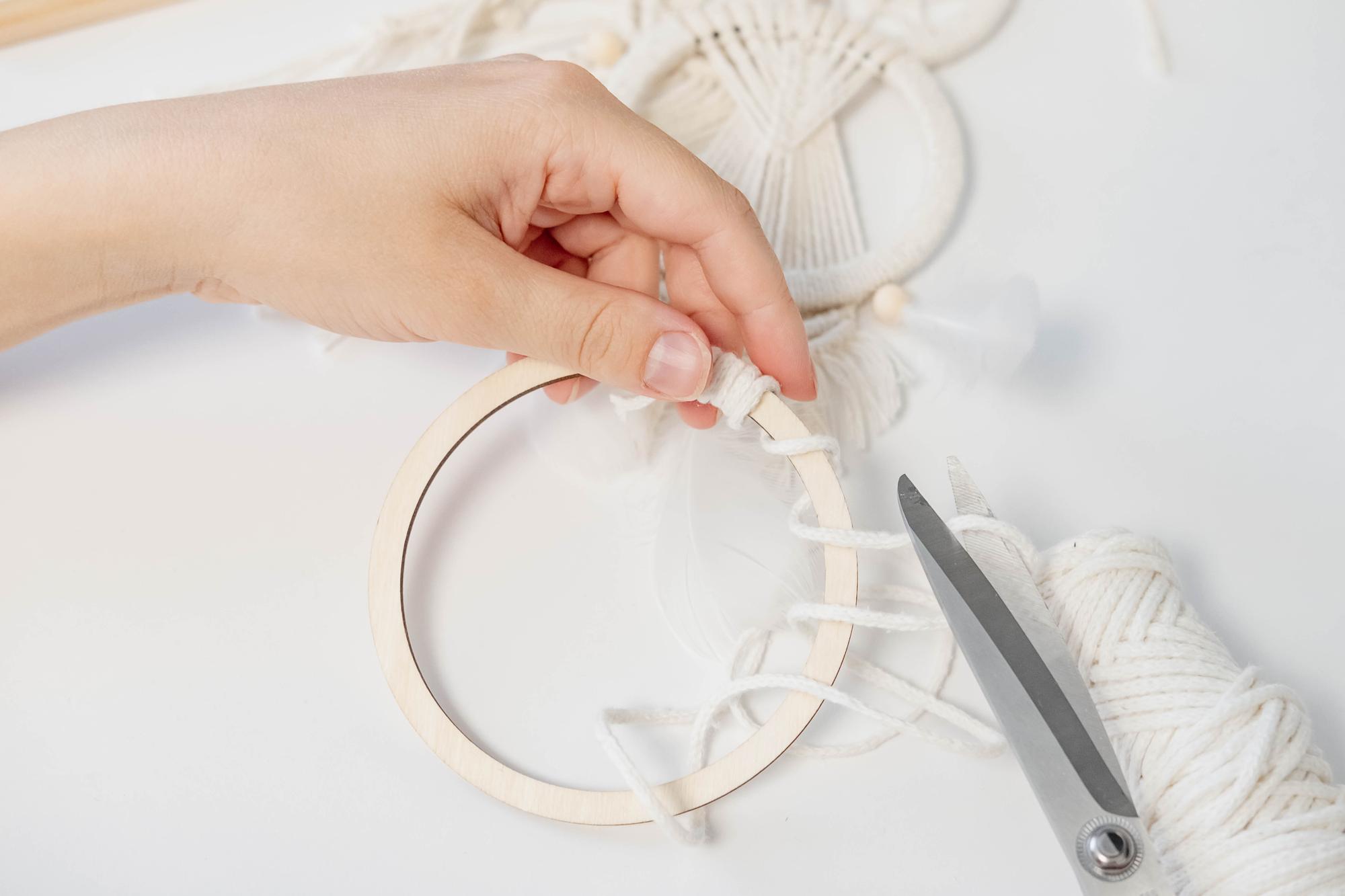 Hands at an embroidery hoop with soft shadows